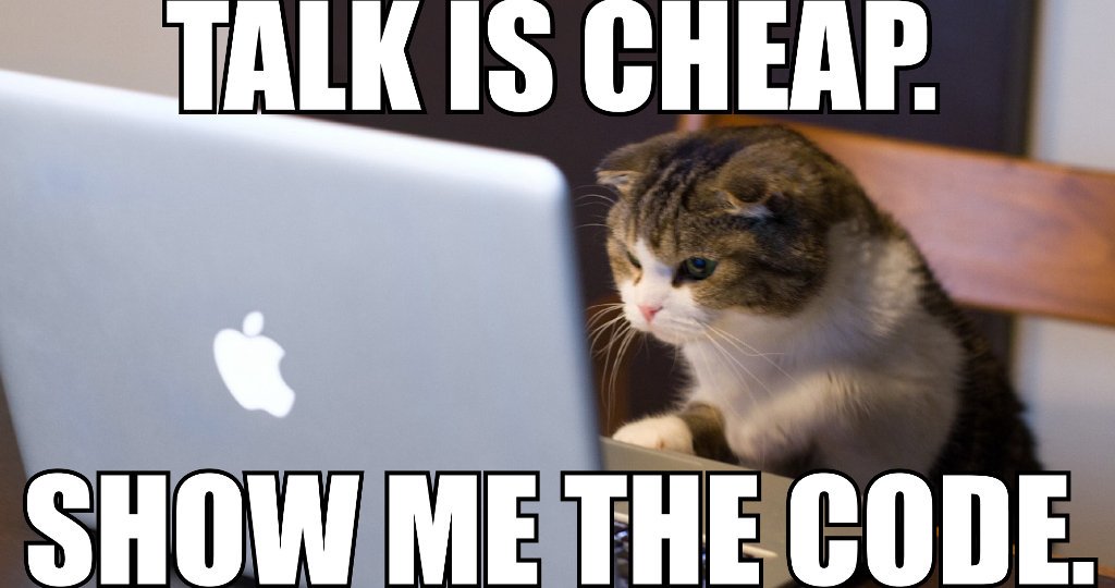 Cat looking at a laptop.